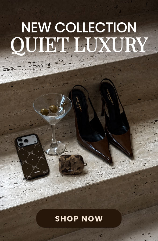 A styled editorial product shot on stone steps featuring a pair of pointed-toe slingback heels in dark brown and black, alongside a martini glass, a phone case, and a small pouch. Large text at the top reads 'NEW COLLECTION QUIET LUXURY' and a 'SHOP NOW' button appears at the bottom.